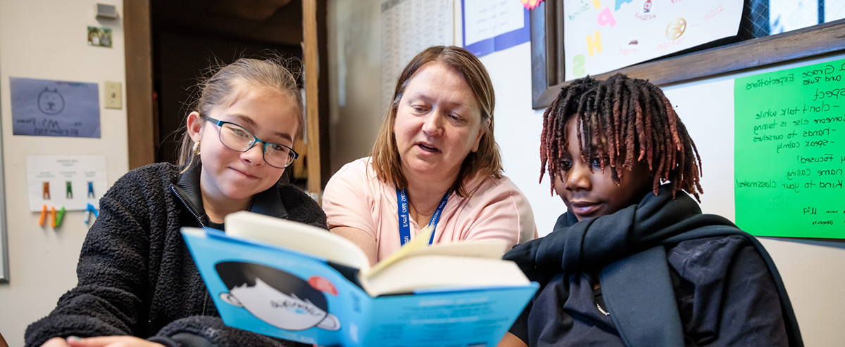 MSU Denver student Patricia Formosa reading a book to children in a classroom.