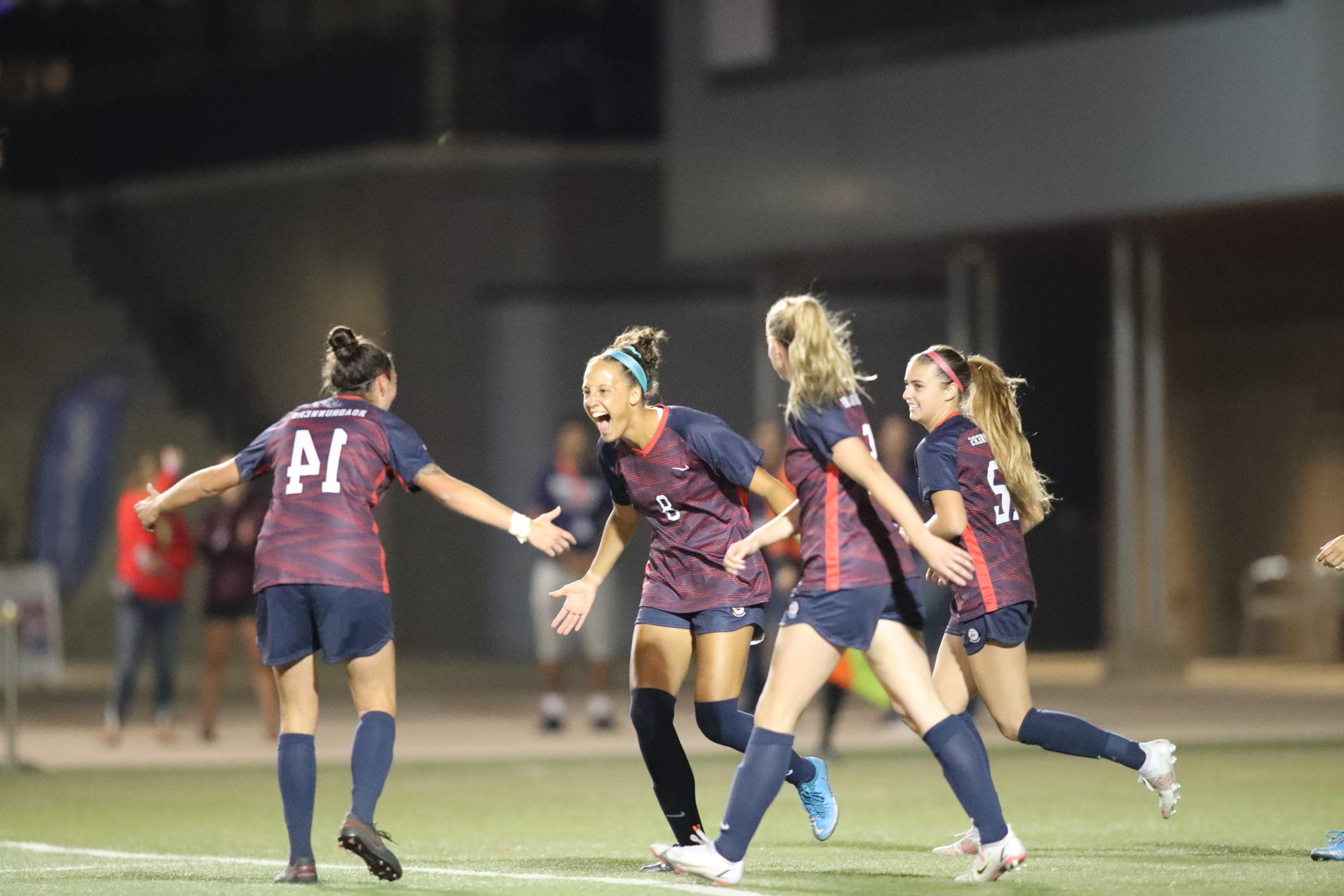 Women's soccer player Elisa Dean celebrates a goal during a night game in 2021.